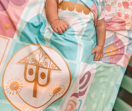 Pastel It's a Small World Swaddle Blanket